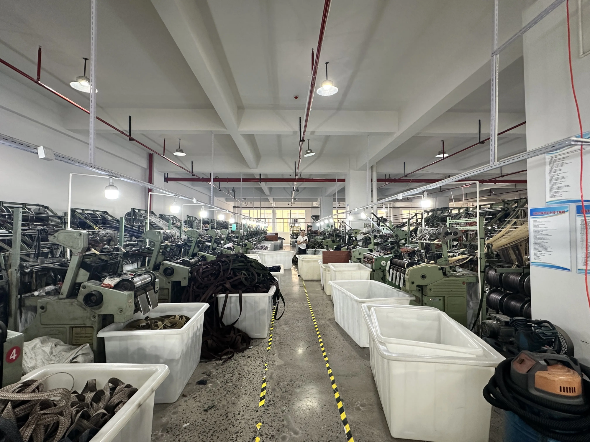 Rows of weaving machines in the webbing factory workshop